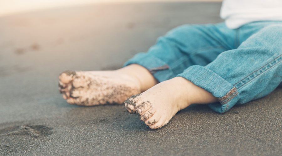 shoeless-feet-baby-sitting-sand